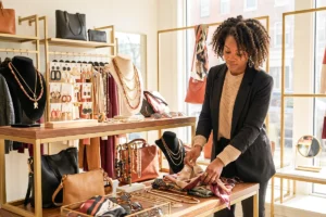 woman arranging jewelry in her store
