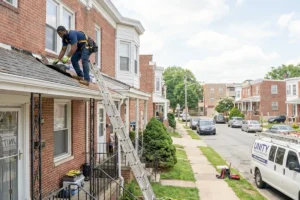 roofing man on a small roof replacing shingles
